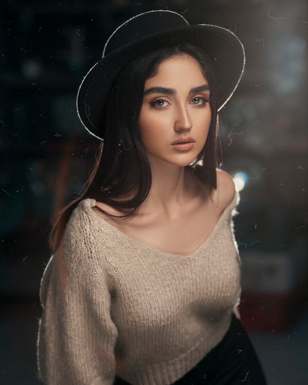 A Woman in Beige Knitted Sweater Wearing a Hat · Free Stock Photo