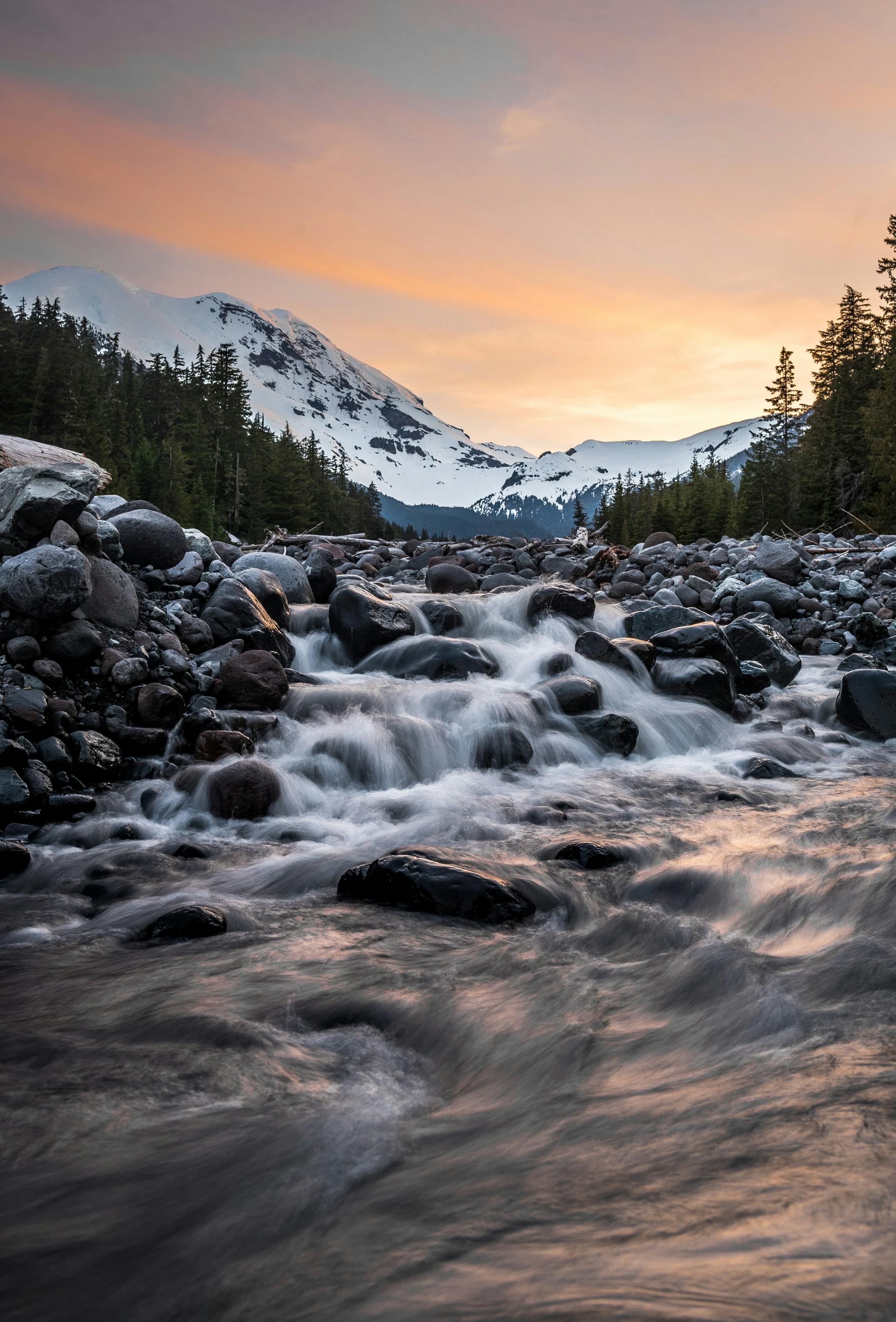 289134 a fast flowing stream surrounded by numerous rocks with a view on a  snowy mountain stream near a white mountain Coolpad Cool 3 Plus  screensaver 720x1520  Rare Gallery HD Wallpapers