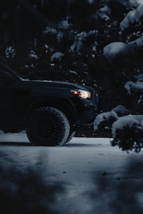 Car with Headlights on in Winter Scenery 