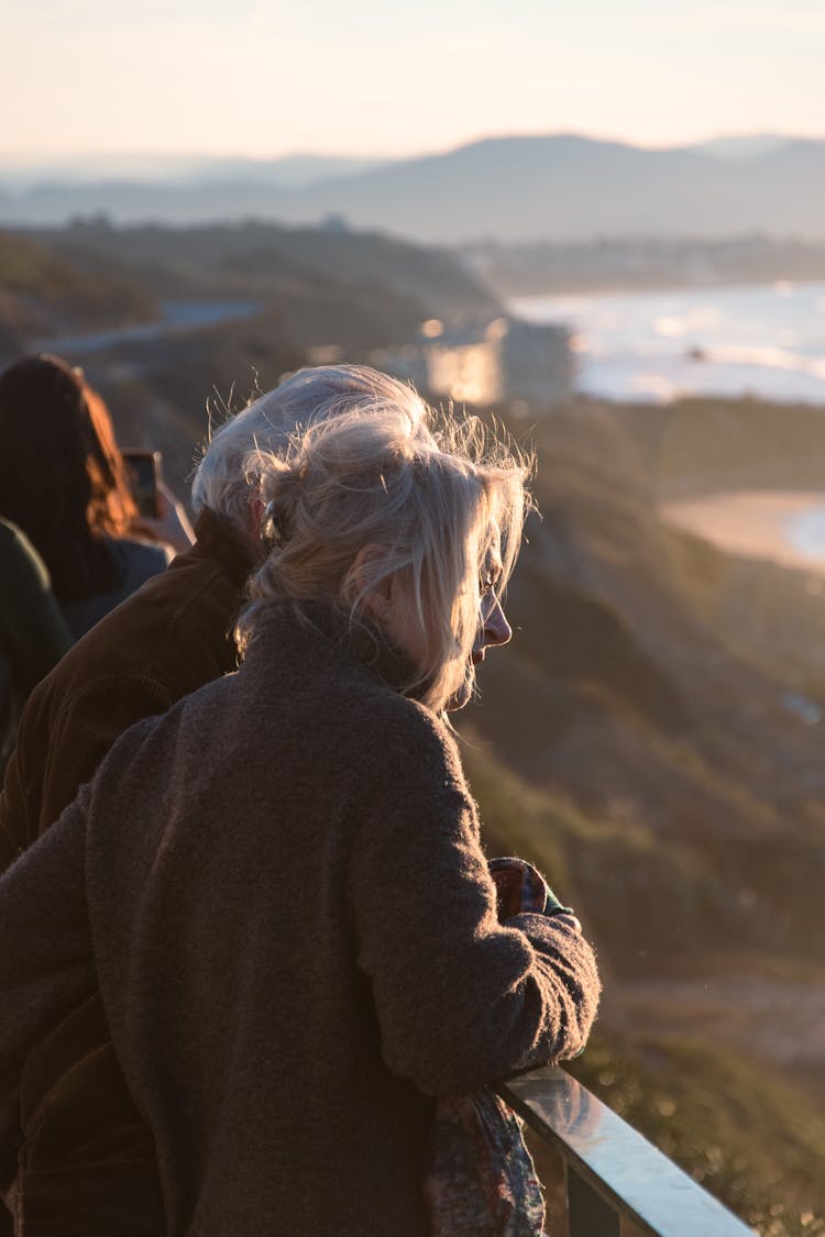 An Elderly Man And Woman Looking At View