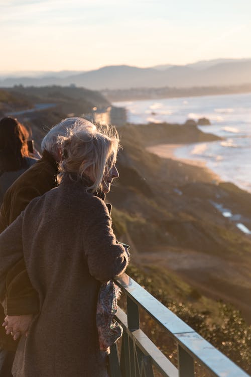 An Elderly Couple Holding Hands Looking at View