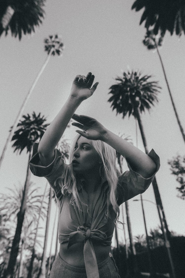 Woman Posing On Palm Trees Background