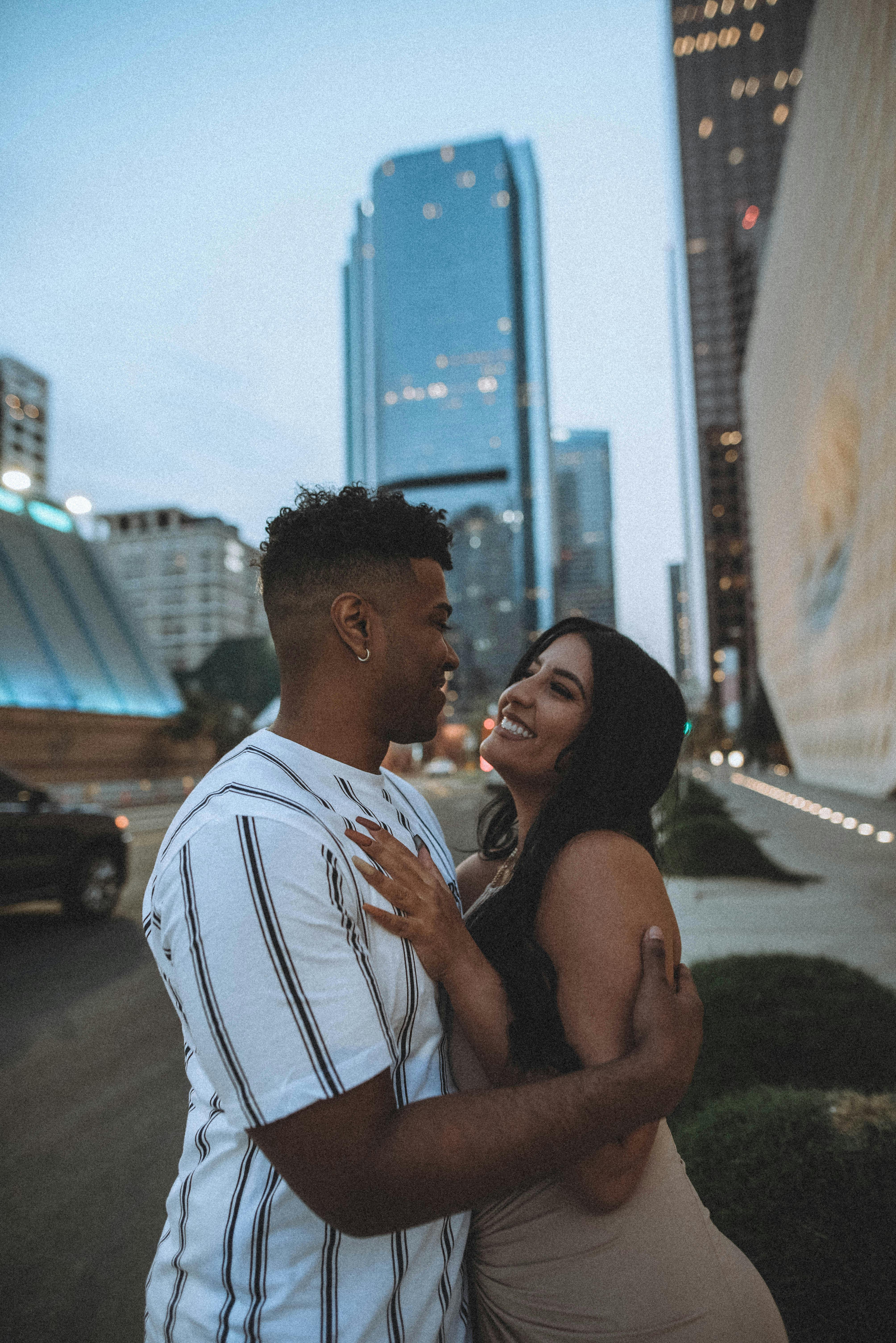 woman and man hugging in city