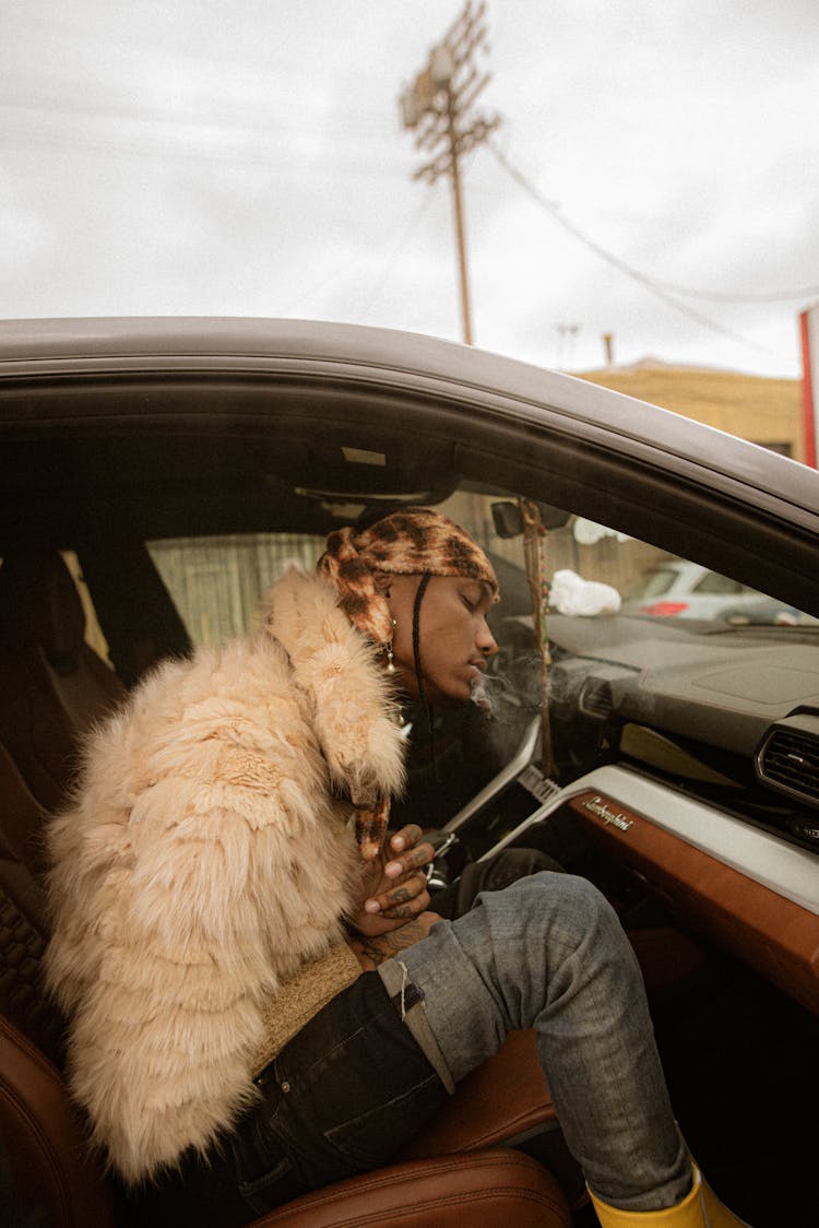 Man Sitting And Smoking In Car