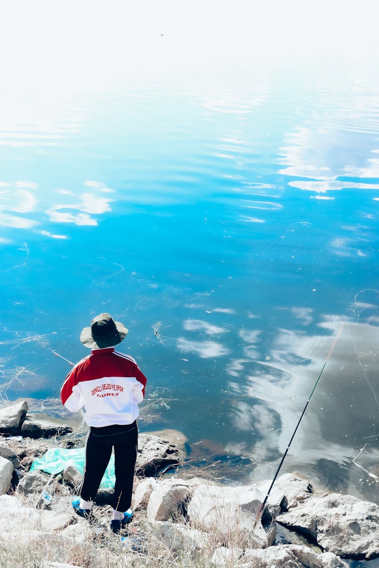 A Man Fishing On The Lake