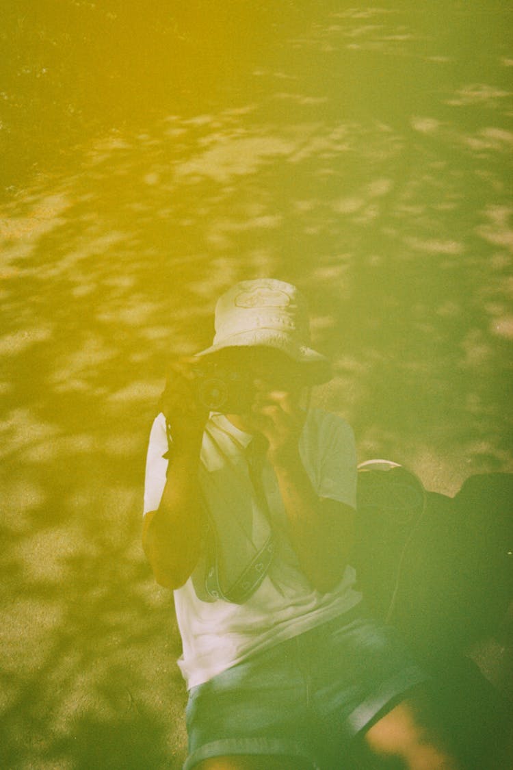 Reflection Of Person Taking Photo With Camera 