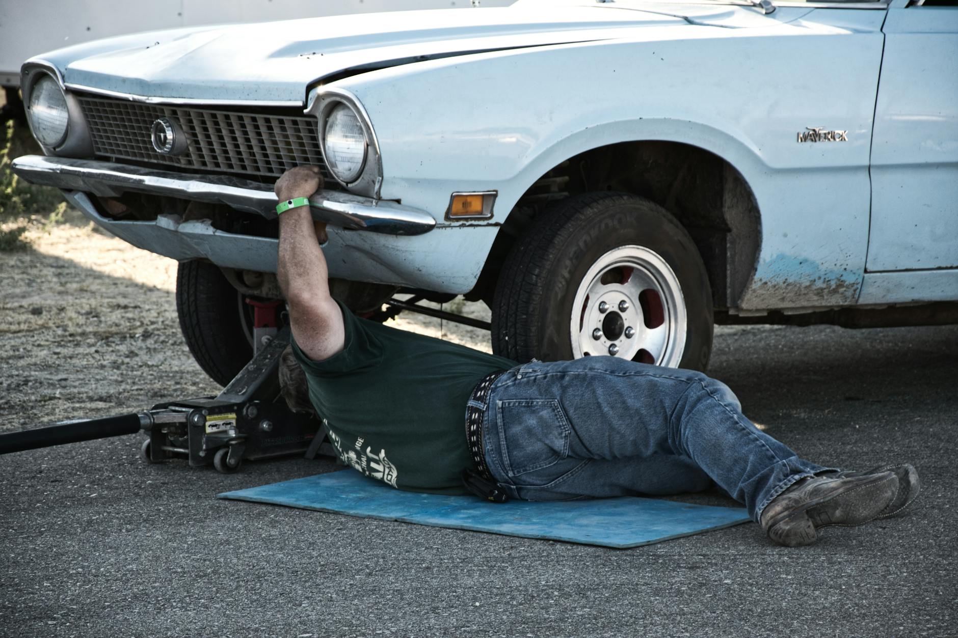 man fixing his car
