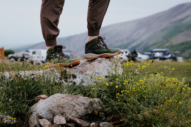 Man Standing On A Rock In Hiking Boots 