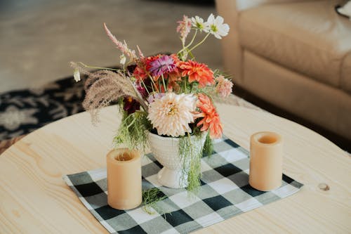 Flowers in Vase and Candles on Table in Living Room