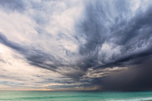 A dramatic sky with storm clouds over the ocean at Malibu beach, capturing nature's raw power.
