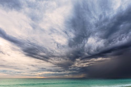 Free A dramatic sky with storm clouds over the ocean at Malibu beach, capturing nature's raw power. Stock Photo