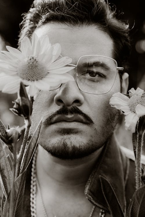 Man in Glasses Posing with Flower