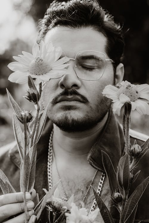 Man in Glasses Posing with Flowers