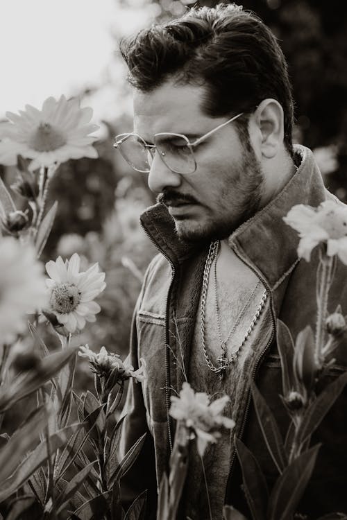 Man in Glasses Posing in Flowers Field