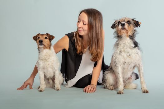 Woman in Black Tank Top Holding White and Brown Long Coated Small Dog