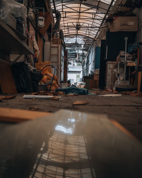 Free Explore the eerie atmosphere of an abandoned Seoul market, filled with debris and decay. Stock Photo