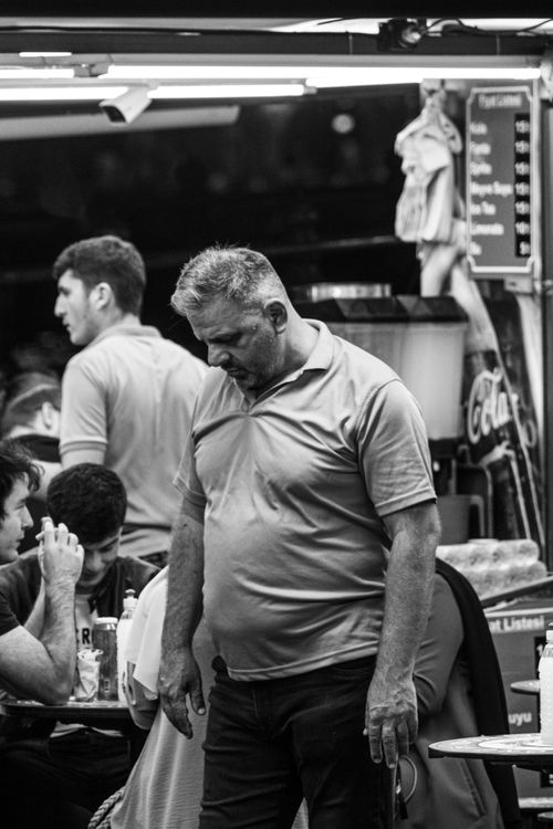 Free A candid black and white photo capturing men in a busy restaurant setting, portraying everyday life. Stock Photo
