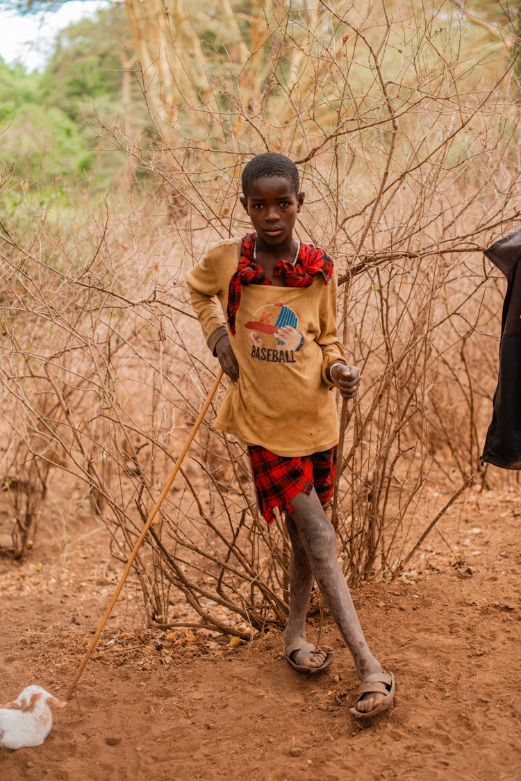 Girl With Dusty Legs Holding Sticks