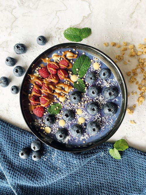 Free Top view of a nutritious smoothie bowl topped with fresh berries and granola. Stock Photo