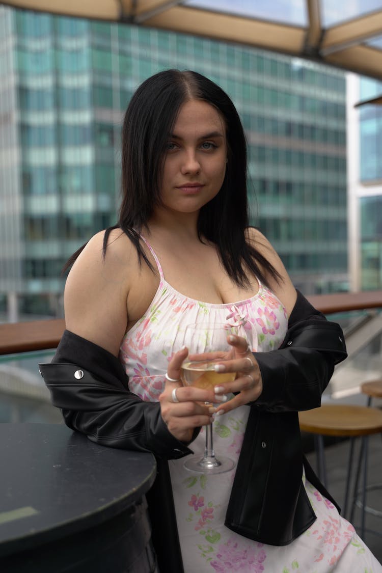 Woman Wearing Floral Dress Holding A Drink