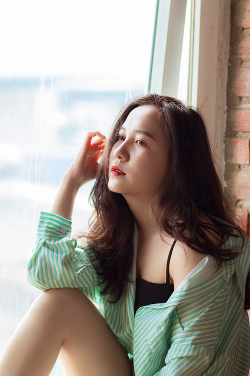 Woman in White Dress Shirt Sitting by the Window · Free Stock Photo