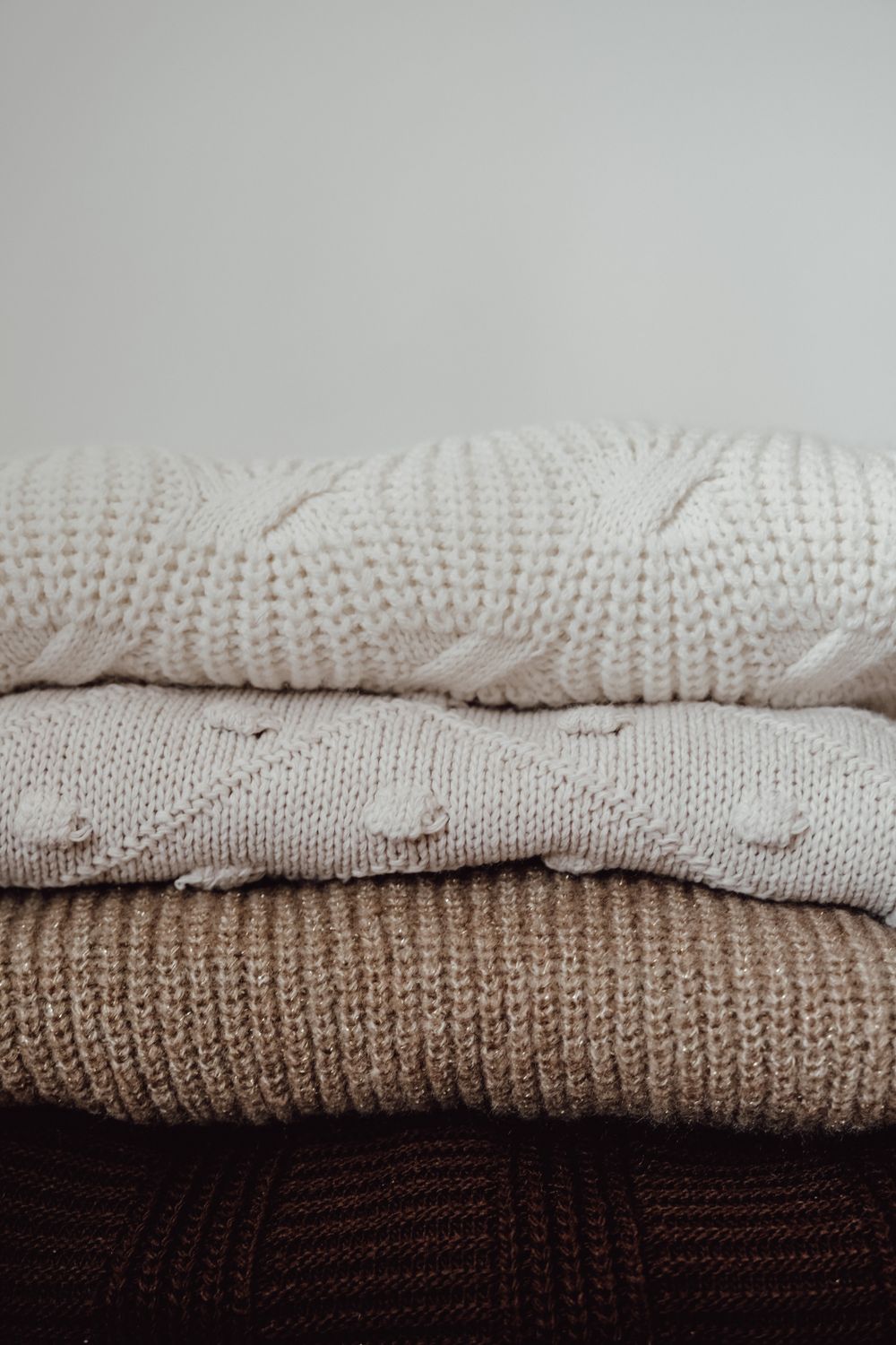 Stack of folded knitted sweaters