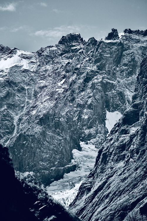 Free Dramatic view of a snow-covered mountain range with jagged peaks. Stock Photo
