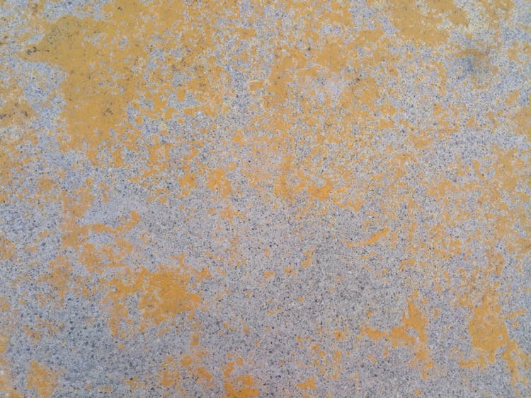 Concrete Surface With Yellow Paint Smudges