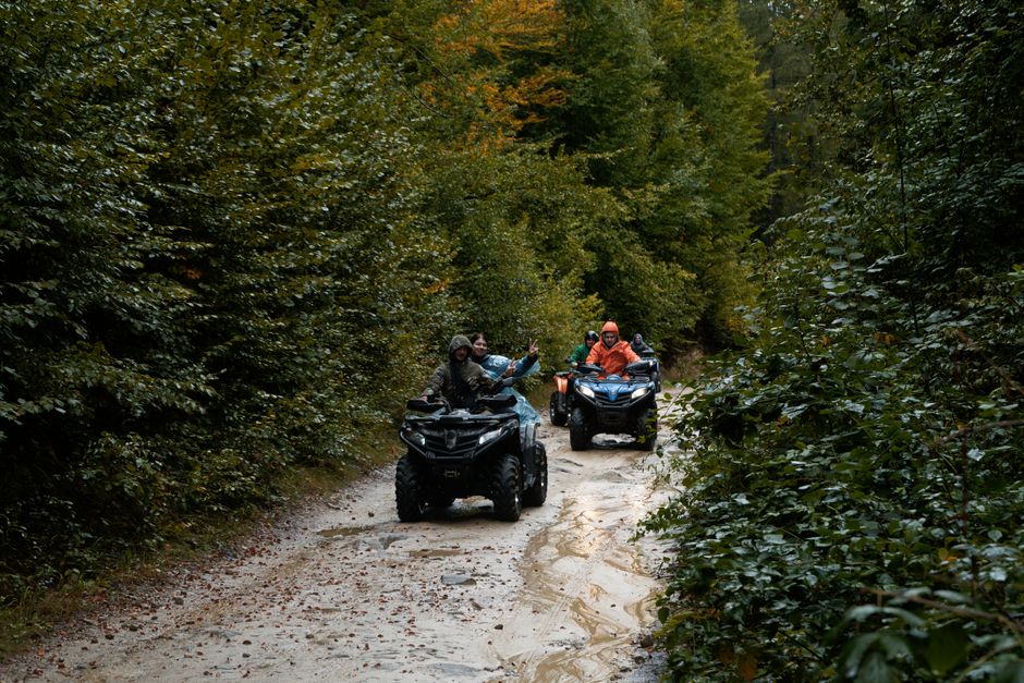 Group enjoying an adventurous ATV ride through a lush forest trail, exploring nature.