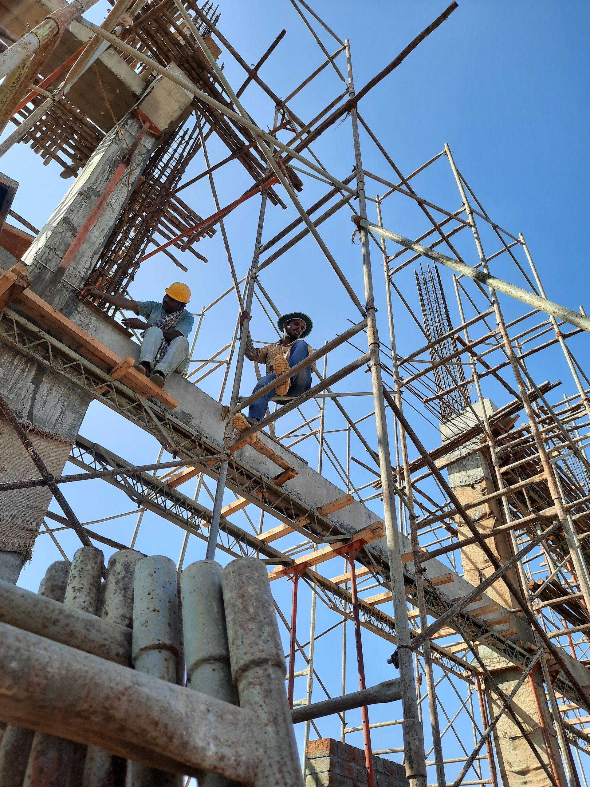 Construction workers on scaffolding at a building site