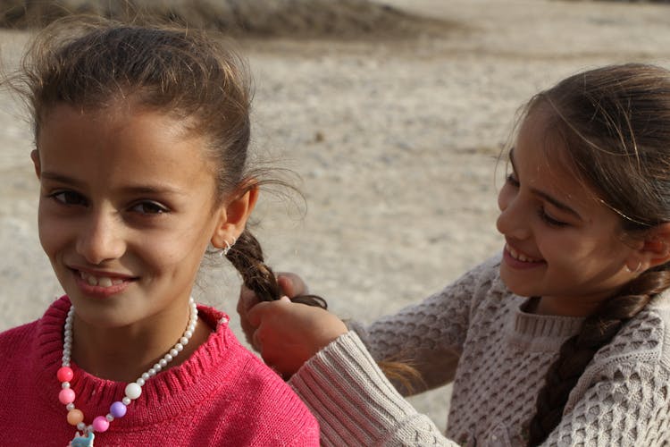 Photograph Of A Girl Braiding Her Friend's Hair