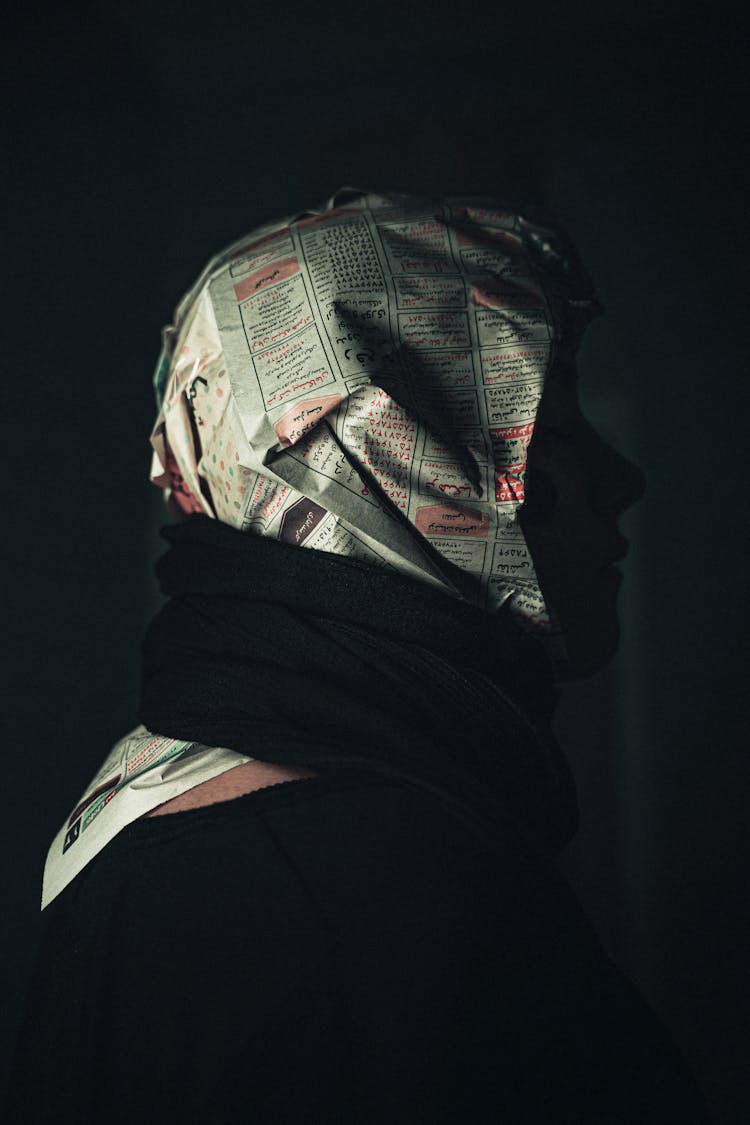 Woman With Newspaper Wrapped Around Her Head