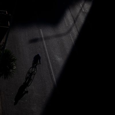 Cyclist silhouetted on a dark street at night — photo by Andy Urdaneta on Pexels