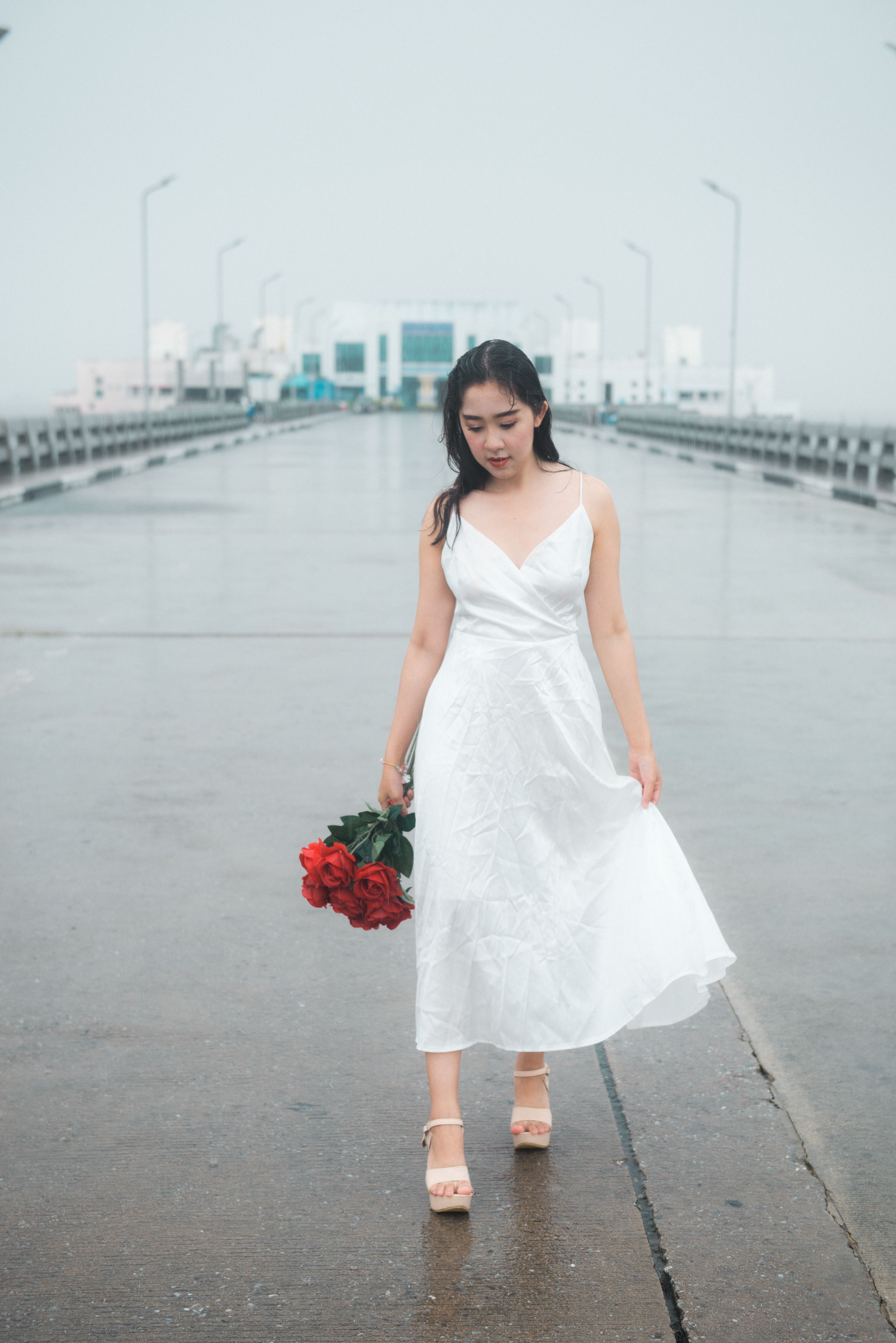 Beautiful Woman in White Dress Holding a Rose · Free Stock Photo