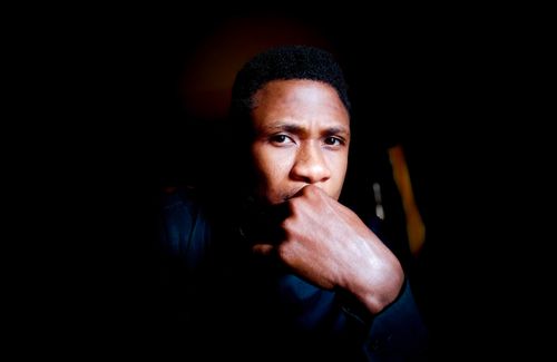 Free Portrait of a thoughtful African man against a dark background, evoking contemplation and introspection. Stock Photo