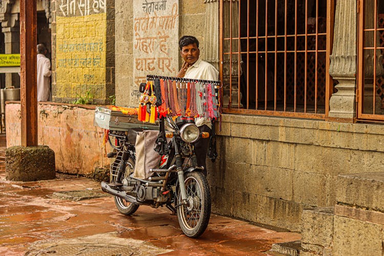 Man Selling Merchandise Using A Motorcycle