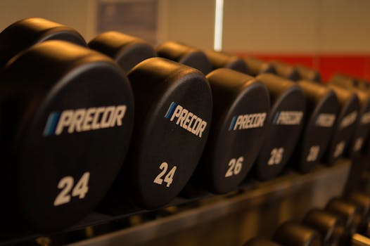 Close-up of Precor dumbbells neatly arranged in a gym for fitness enthusiasts.