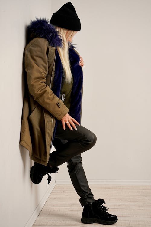 Woman in Outerwear Posing in White Studio