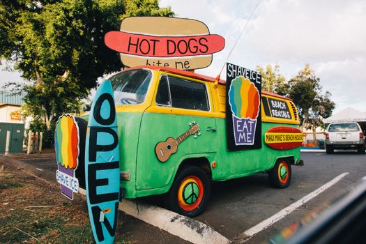 Colorful vintage food truck offering shave ice and hot dogs in Kaanapali, Hawaii.