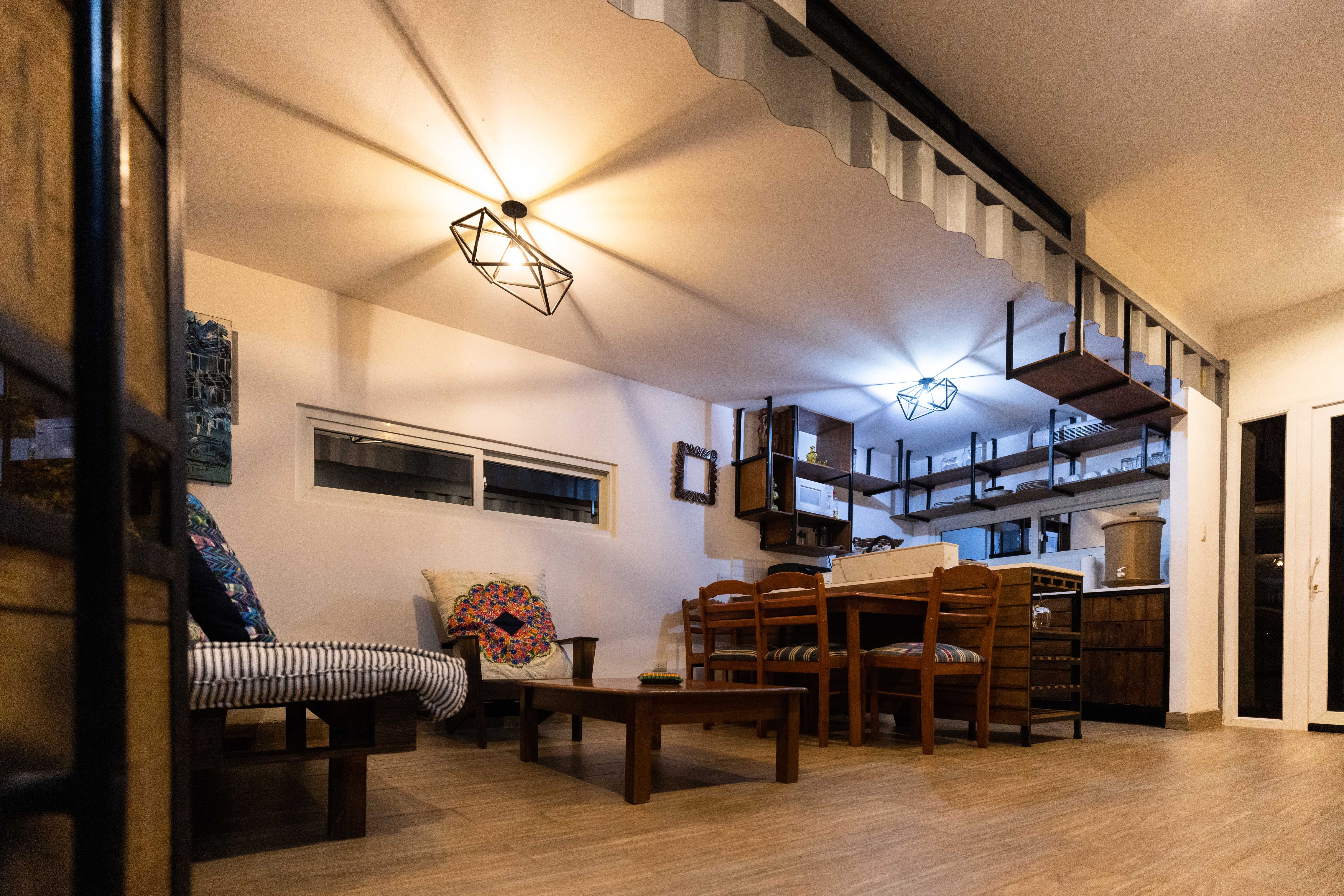 Minimalist Japanese-inspired tiny home interior with natural wood accents and industrial lighting