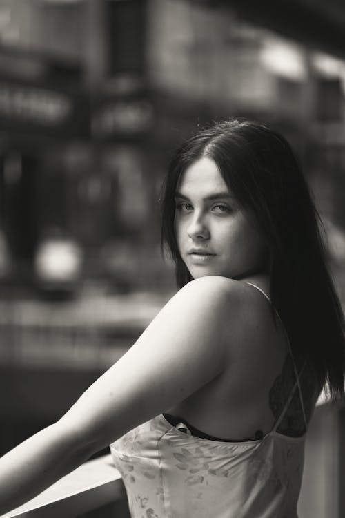 Black and White Photo of a Woman Looking Over Her Shoulder