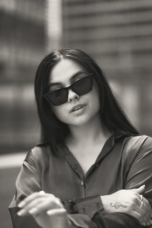 Grayscale Photo of a Beautiful Woman Wearing Sunglasses