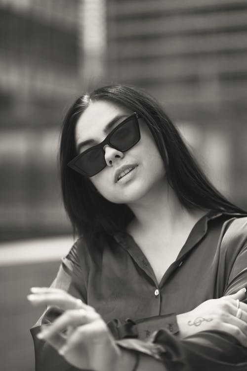 Grayscale Photo of a Beautiful Woman Wearing Sunglasses