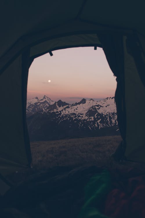 View from Tent on Mountains in Snow on Sunset