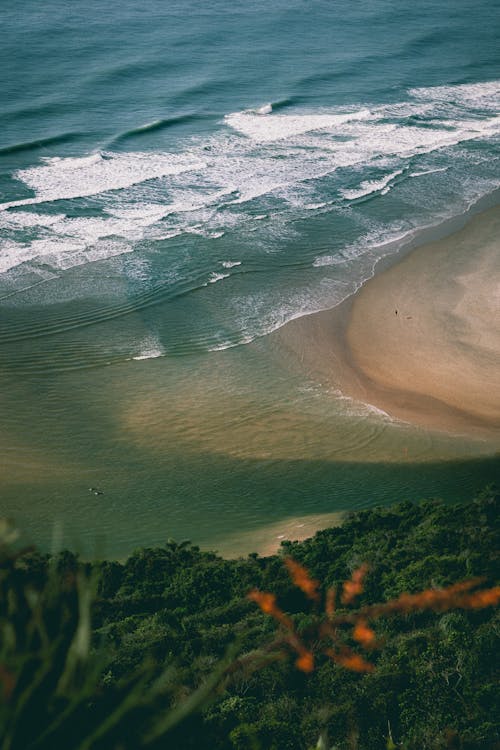 High-Angle Shot of Waves Crashing on the Seashore