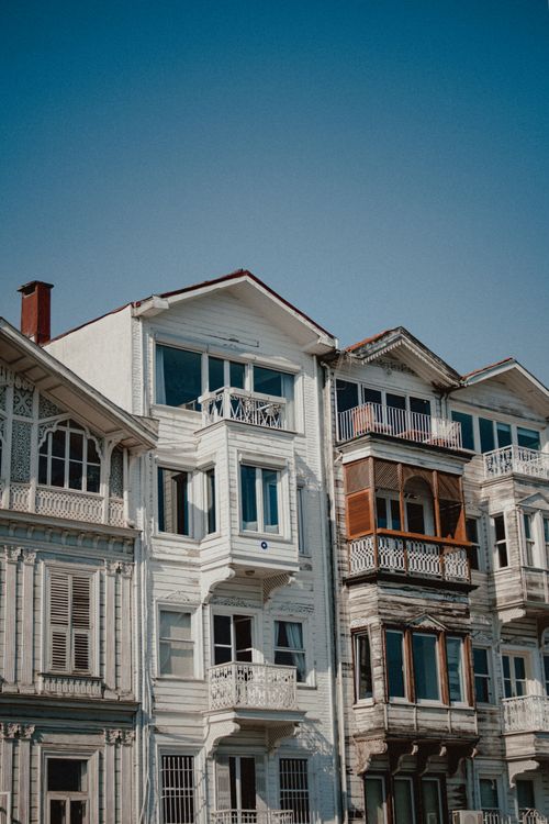 Free Beautiful wooden facades of traditional houses under a clear blue sky, showcasing intricate architecture. Stock Photo