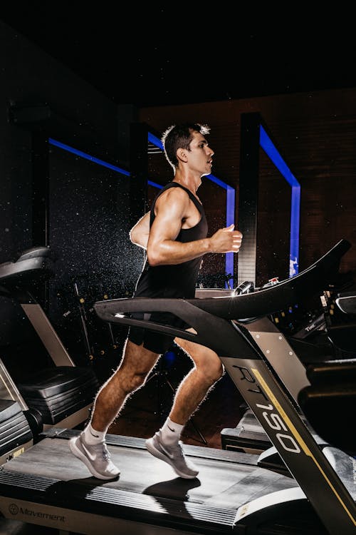 Free Man Running on a Treadmill Stock Photo