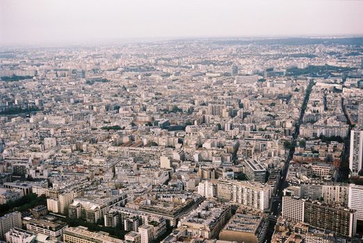 Expansive aerial view of Paris displaying dense urban architecture and skyline from above.