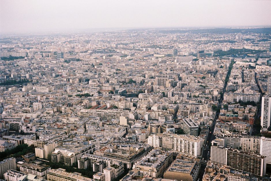 Expansive aerial view of Paris displaying dense urban architecture and skyline from above.