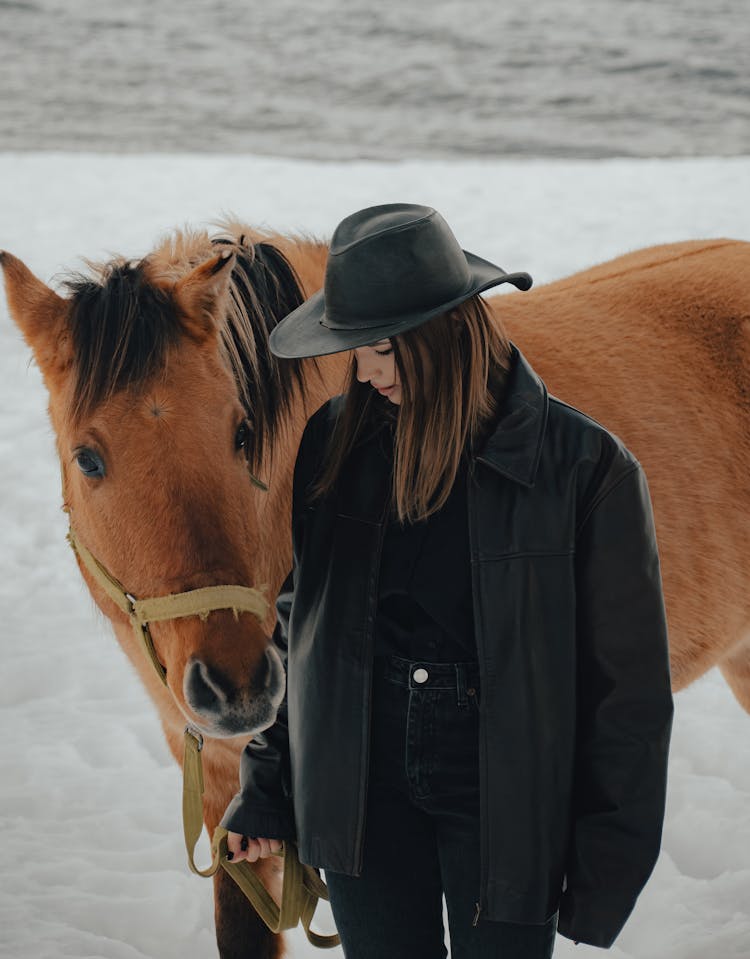 Woman Wearing Warm Clothing With Horse